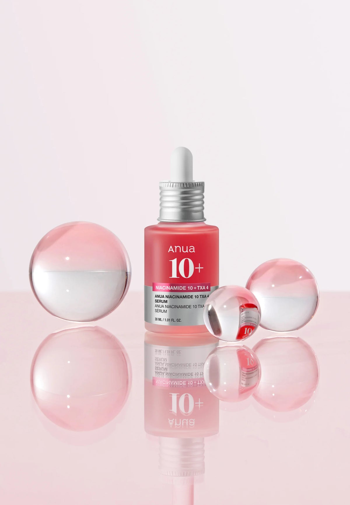 Anua serumflesje tussen roze bollen